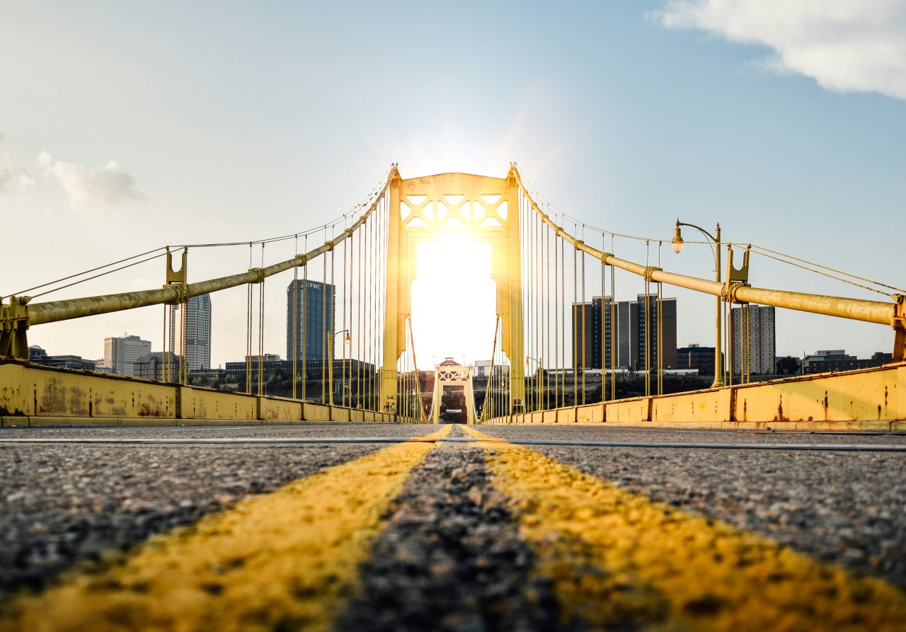 Ground-level image of a bridge leading into the city of Pittsburgh